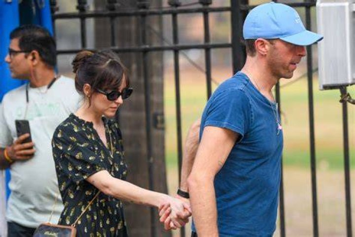 Dakota Johnson & Chris Martin Hold Hands In Rare PDA Photos After Her Movie Premiere