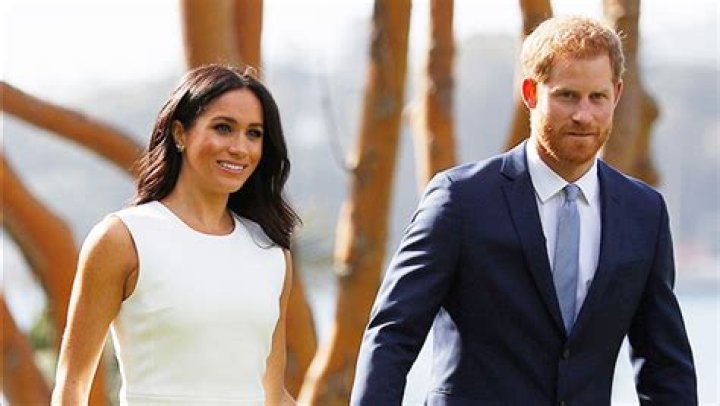 Meghan Markle & Prince Harry Smile Mysteriously, Hold Hands In New Photos From Recent U.K. Visit